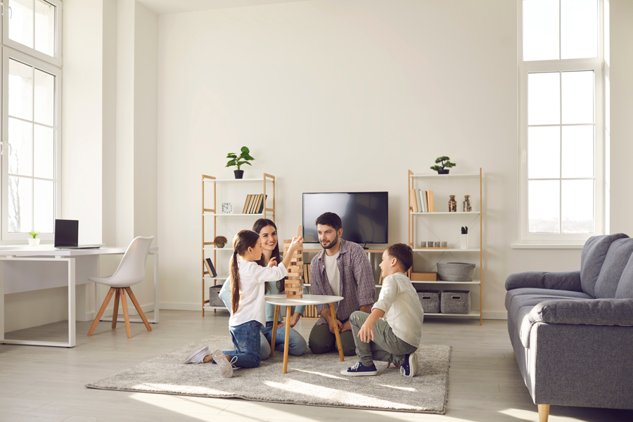 Parents and children enjoying playtime together in a living room