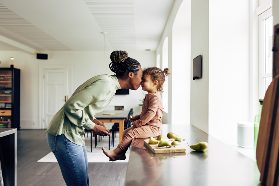 A mother and child standing in front of a counter.