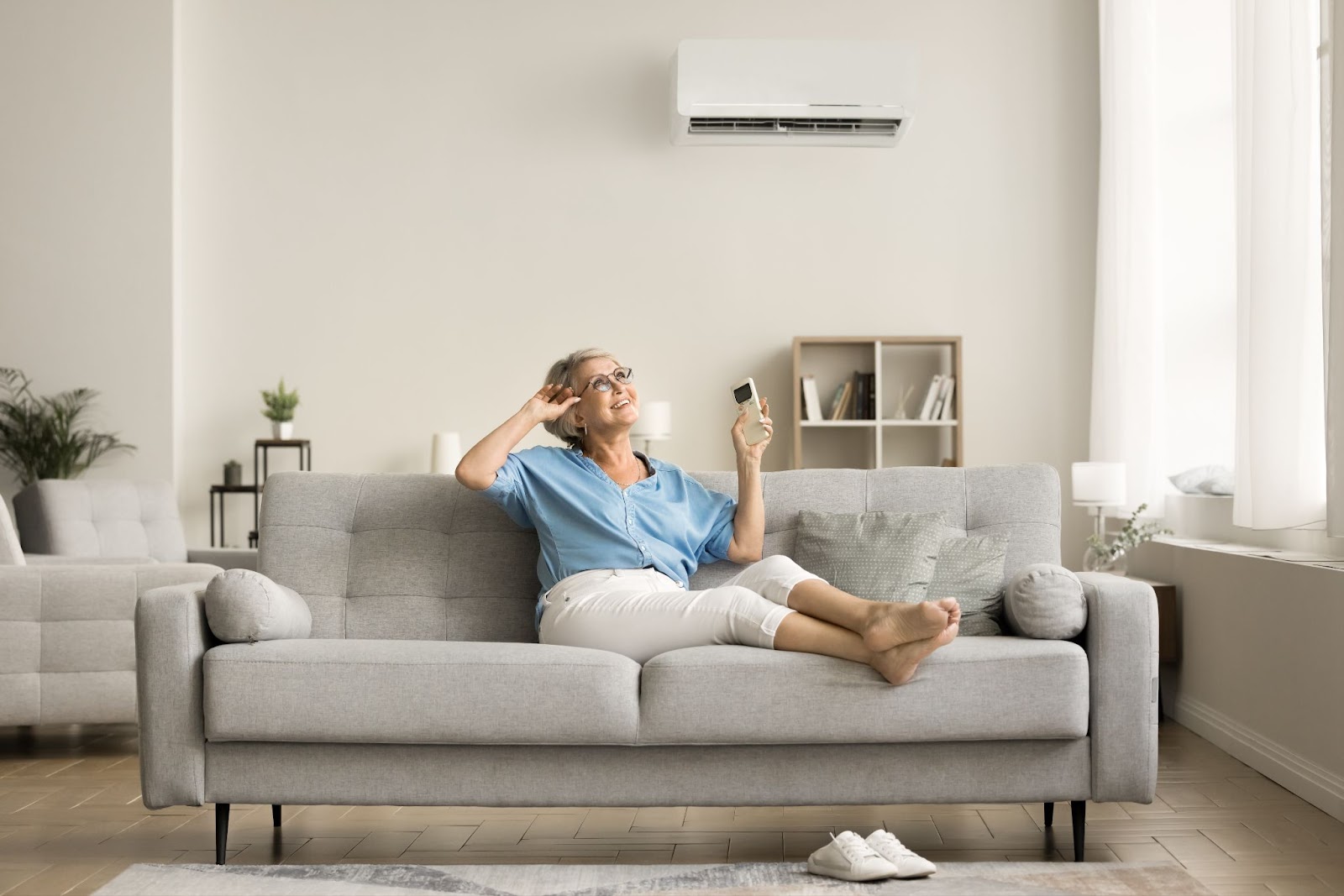 A woman seated on a couch, engaged with her cell phone, highlighting comfort and modern living.