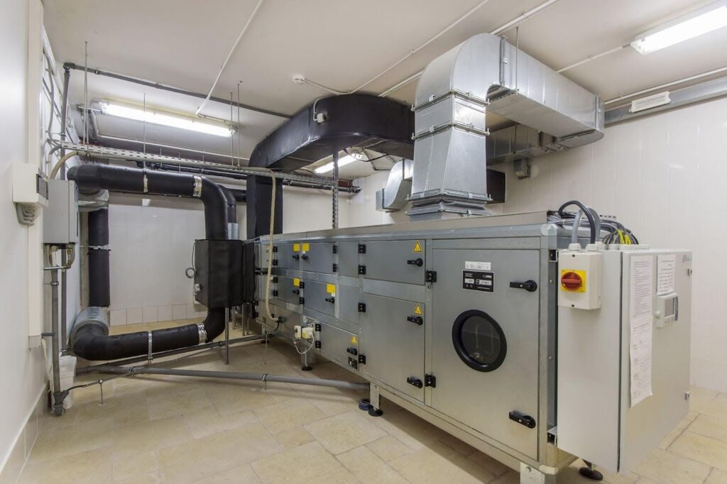 A large industrial air conditioning unit installed inside a commercial building